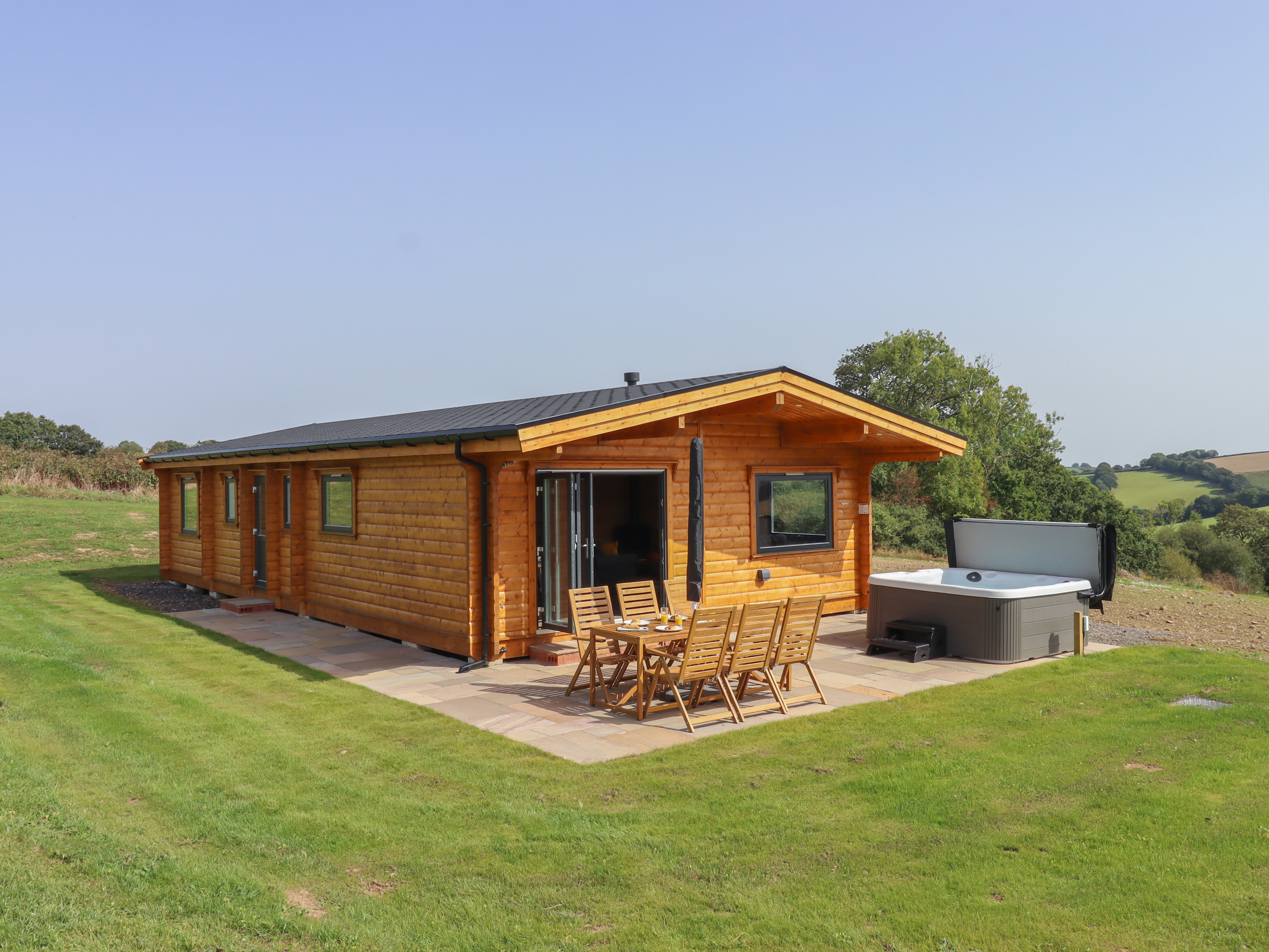 Primrose Lodge in Hittisleigh, Devon. Detached lodge. Open-plan living space with woodburning stove.