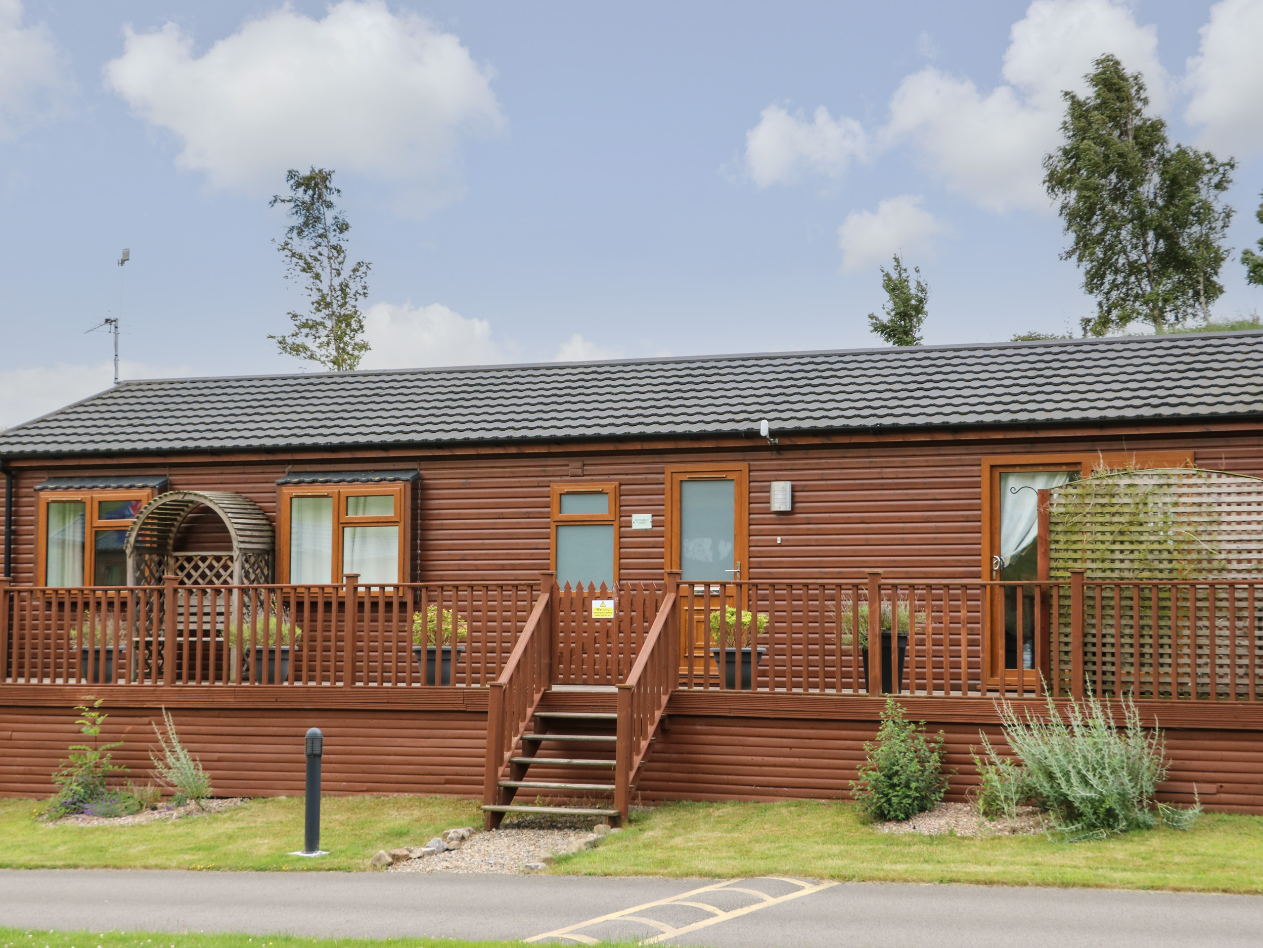 Butterfly Lodge, North Yorkshire. Two-bedroom lodge with hot tub and pet-friendly garden.