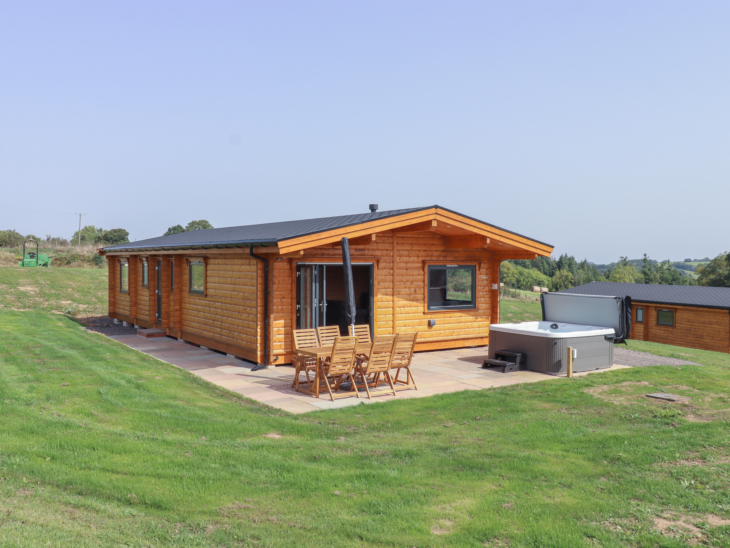 Foxglove Lodge in Hittisleigh, Devon. Detached lodge. Open-plan living space with woodburning stove.